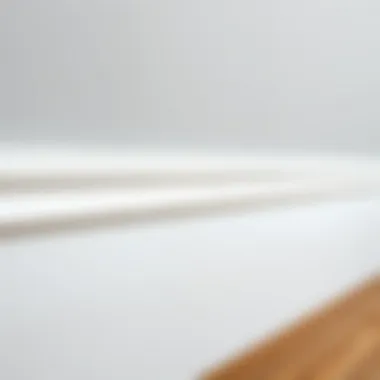 Close-up of white skirting board highlighting texture