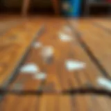 Close-up of dried paint stains on a wooden floor